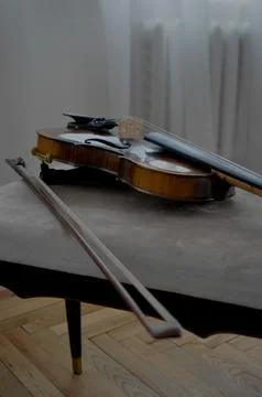 Violin bow next to it on the couch Stock Photos