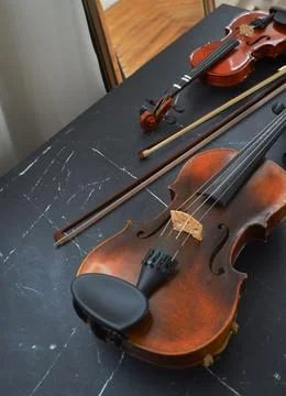Violin bow next to it on the couch Stock Photos