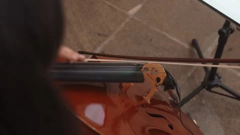 Violin bow playing strings of wooden violin during music performance Stock Footage 331742311