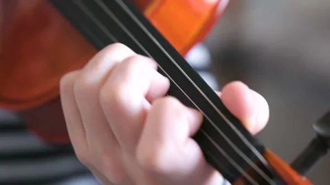 Violin in boy's hands. Boy is learning to play violin. Correct setting of the Stock Footage 102826817