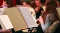 Violin concert female playing by note sheets music, classics HD Footage