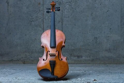 Violin on concrete wall Photos