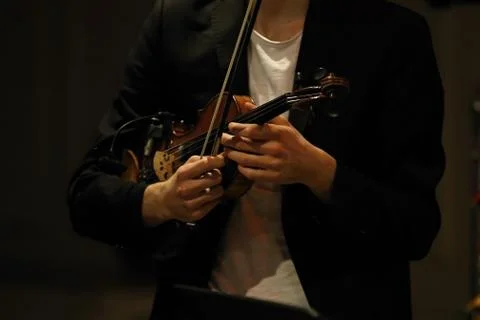 Violin in the hands of a musician Stock Photos