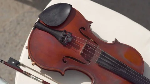 Violin lying on a chair at a wedding ceremony Stock Footage