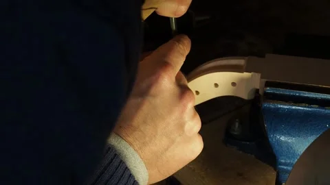 Violin Maker Carving Scroll Curve by Hand with Tool Held in Vise Video stock 313121380