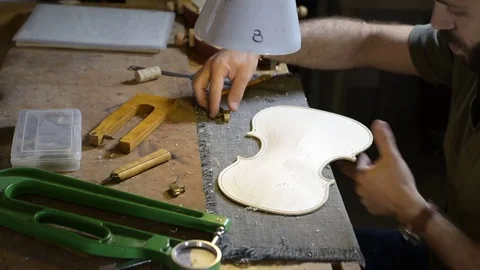 Violin maker sculpts wood Stock Footage 75948457