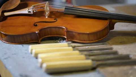 Violin maker studio focus changing on violin and tools Stock Footage 75951792