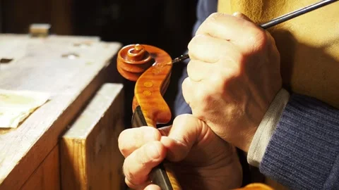 Violin Maker Varnishing Scroll with Fine Brush Using Traditional Handcrafted Stock Footage 313117720