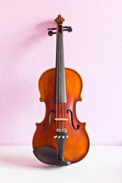 Violin on pink wall Stock Photos