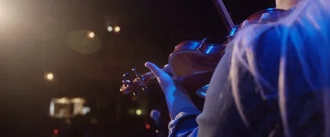 Violin Player performs on stage under spot light Stock Footage 124775894