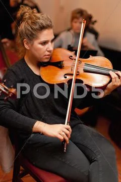 Violin Player Practicing With Group