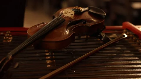 Violin resting on marimba bars, intimate studio still life Stock Footage 337938921