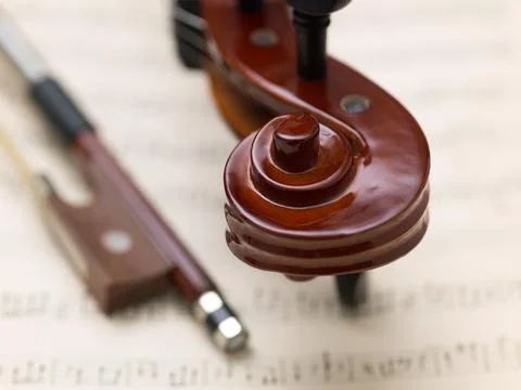 Violin Scroll and Bow Frog on Vintage Sheet Music Stock-Fotos