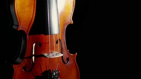 Violin spins in the studio on a black background. Close-up of the violin turns Video stock 148977186