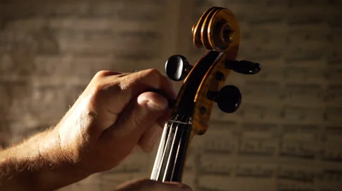 Violin tuning. Dramatic concert lighting and musical notes on background Stock Footage 65413452
