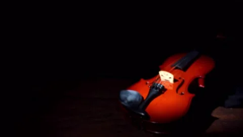 Violin, violin totally out of focus on a table, until it gets the focus rig.. Video stock 241670895