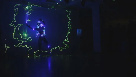 Violinist with an electronic LED violin in the rays of a laser.laser show Video stock 117160543