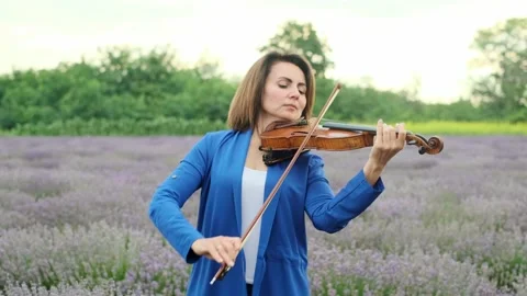 Violinist playing in lavender field Stock Footage 201853757