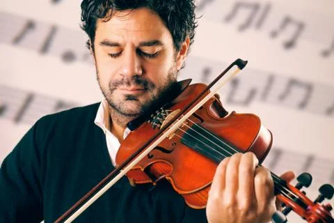 Violinist playing with a stave background Stock Photos