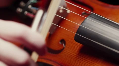 Violinist puts a bow on the strings of the violin and prepares to play, close-up Stock Footage 151195090