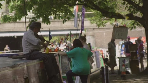 Violinist sitting on barge playing Stock Footage 93201289