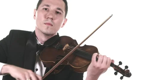 Violinist in tuxedo performs a slow composition on a classical violin. Isolated Stock Footage 134495503