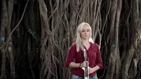 Violinist in the woods preparing to perform Stock Footage 148414973