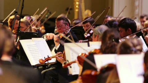 Violinists playing classical music with orchestra Stock Footage