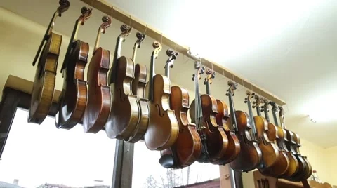 Violins hanging from a rack 스톡 동영상 47747319