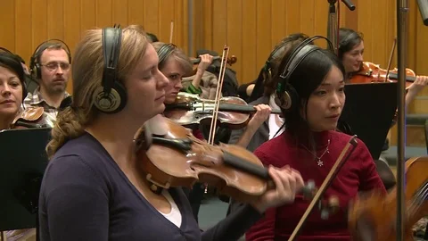 Violins playing within Symphonic Orchestra Recording Stock Footage 97731523