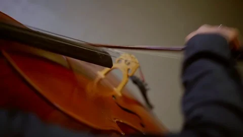 Violoncellist is playing classical music in orchestra, top view on his hand Stock-Footage 99569079