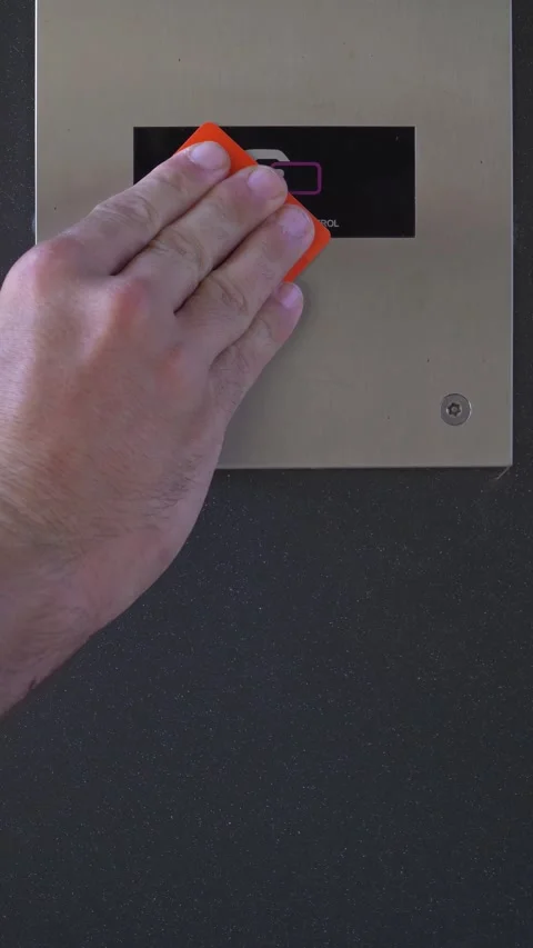 VIP approaching contactless card to reader in order to unlock security control	 Stock Footage 280876711
