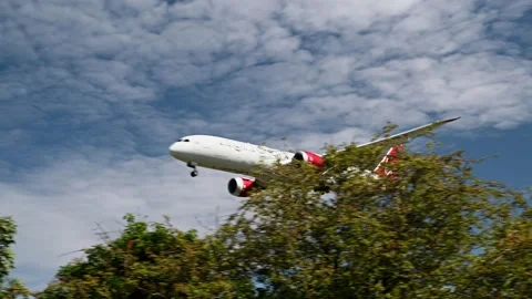 Virgin Atlantic Dreamliner in a low flight over the trees Stock Footage 262467746