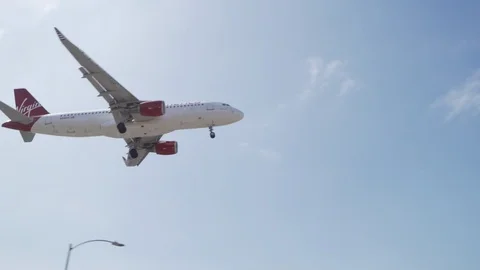 Virgin jet plane flying into LAX airport and landing Stock Footage 89185933