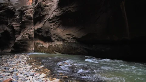 The Virgin river rushing between the high canyon walls of Zion National Park. Video stock 119347198