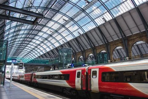 Virgin train is at The Kings Cross train Station in central London. Stock Photos