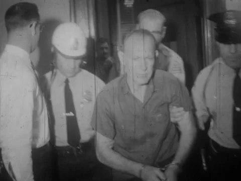Virginia - 1960s: Man escorted through station by police (slow motion) Stock Footage 234240344
