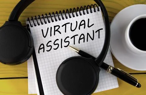 VIRTUAL ASSISTANT - words on a white notepad on a yellow background with he.. Stock Photos