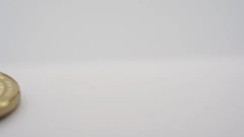 Virtual bit-coin coin appearing on a white background Stock Footage 124807644