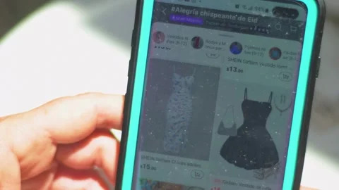 Virtual Fashion. Hand touching screen smartphone to shopping clothes. Use Stock Footage 310314668