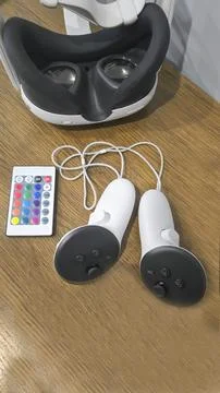 Virtual game set. VR headset. Glasses are on the table next to the control pa Stock Photos