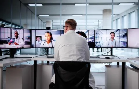 Virtual Job Interview With Young Man In Office Using Computer Stock Photos