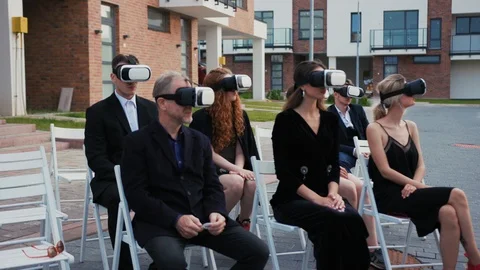 Virtual property auction. View of beautiful formal people wearing VR headsets Stock Footage 113922716