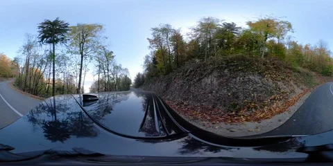 Virtual reality 360 degree view of car driving on a asphalt road in a forest Stock Footage 118714677