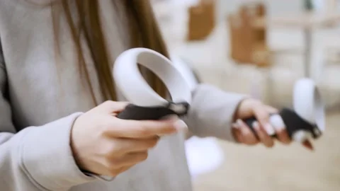 Virtual reality, controllers in the hands of a young woman close-up. Stock Footage 192320517