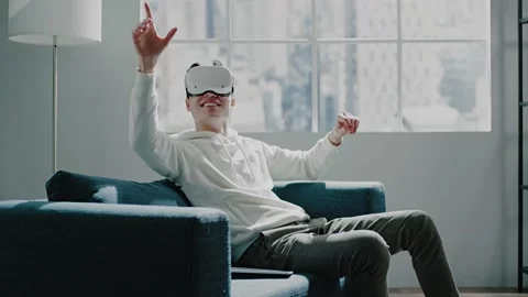 Virtual reality developer in headset smiles and moves hands Stock Footage 154842252