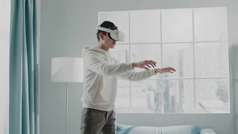 Virtual reality developer man in new headset tests product Stock Footage 152148379