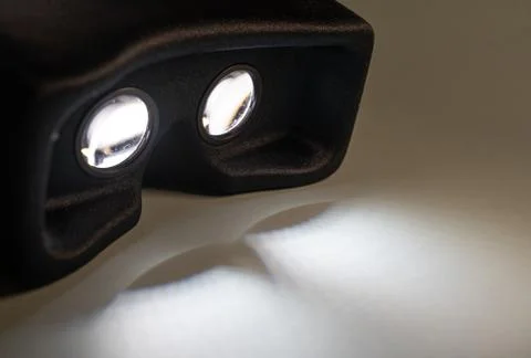 Virtual reality device on, casting light shadows Stock Photos