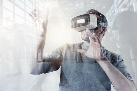 Virtual Reality Experience Conceptual Image with Young Men Wearing Modern VR Stock Photos