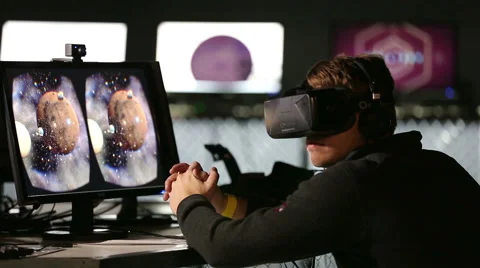 Virtual reality game. Young man uses a head mounted display Oculus Rift. Stock Footage 57517685